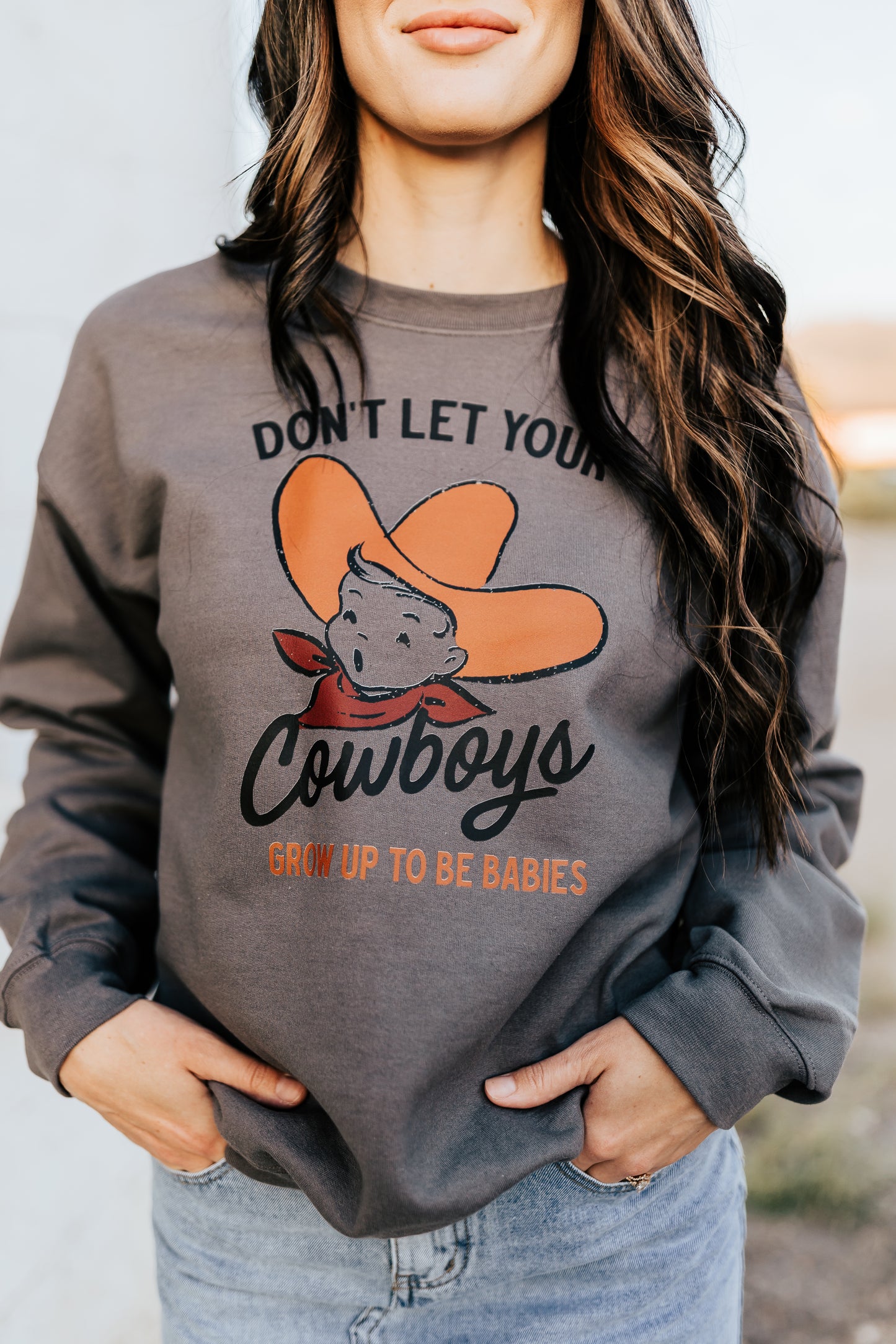 DON’T LET YOUR COWBOYS GROW UP TO BE BABIES SWEATSHIRT